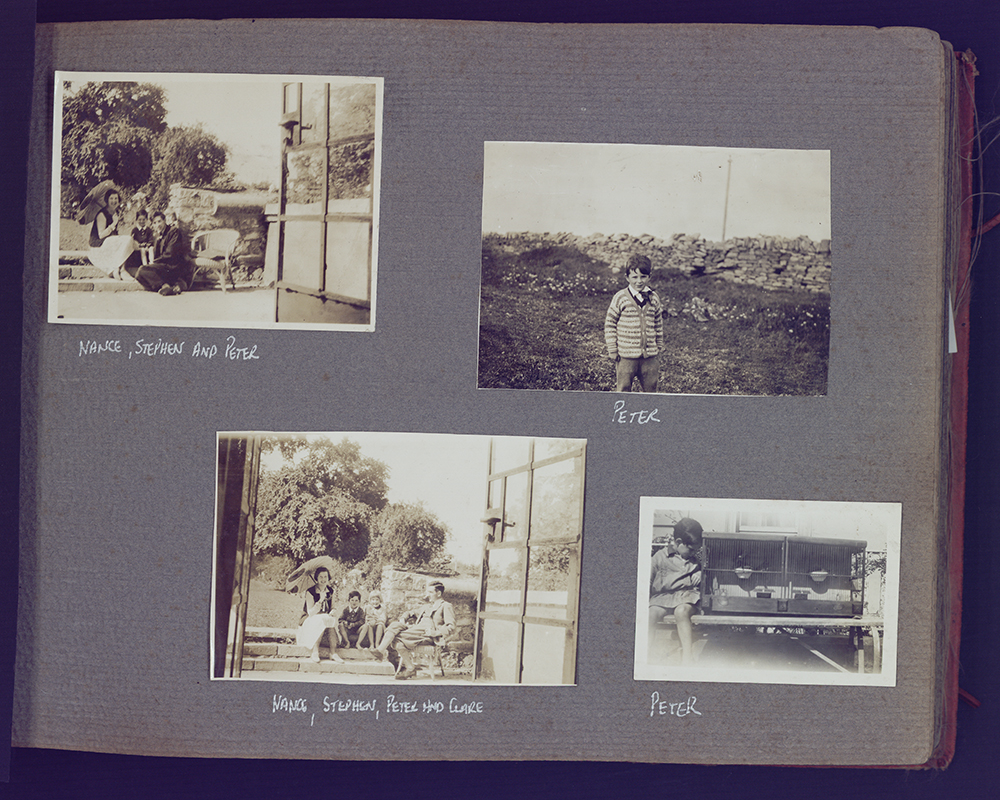 Four black and white photographs stuck to a larger grey page